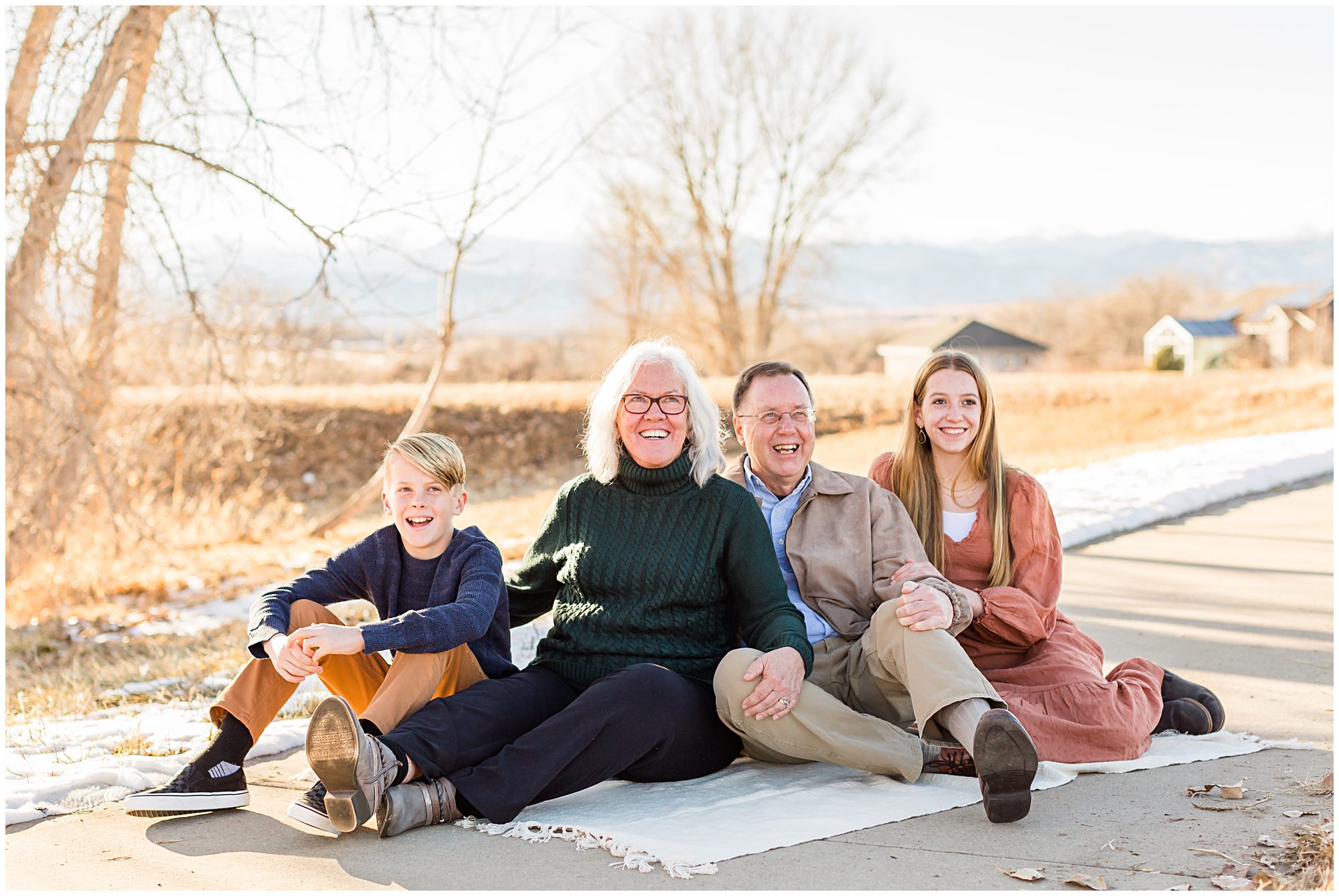 Grandparents and their grandchildren share a joyful moment during an extended family session in Erie Colorado