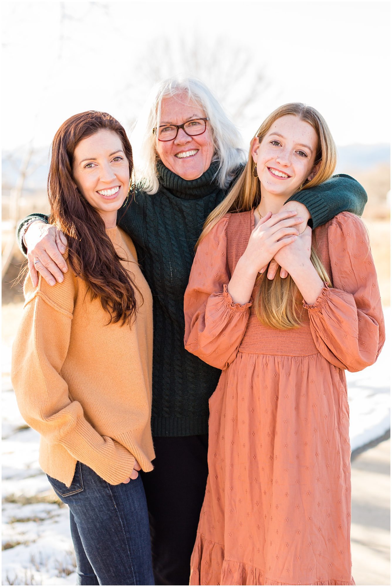 Three generations of women embrace during an extended family portrait session in Erie Colorado