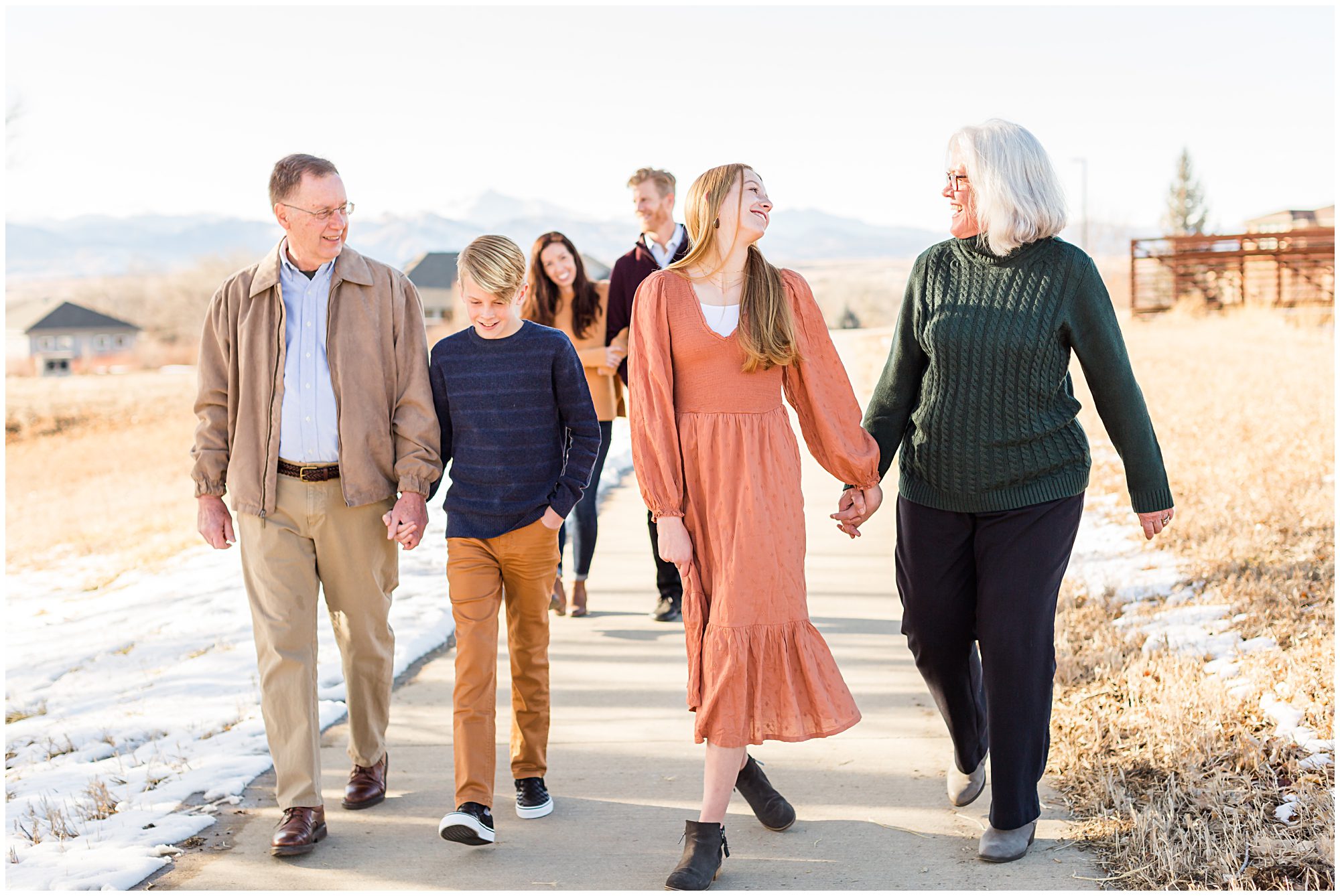 An extended family walking along a trail during an outdoor family session in Erie Colorado