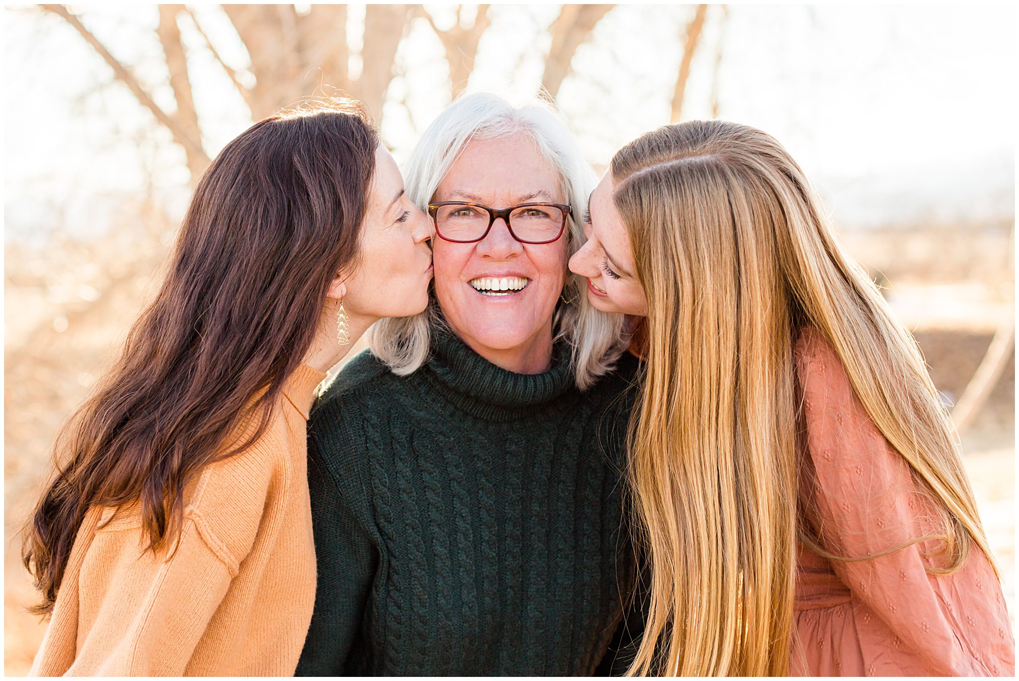 Three generations of women share a joyful moment during an extended family portrait session in Erie Colorado