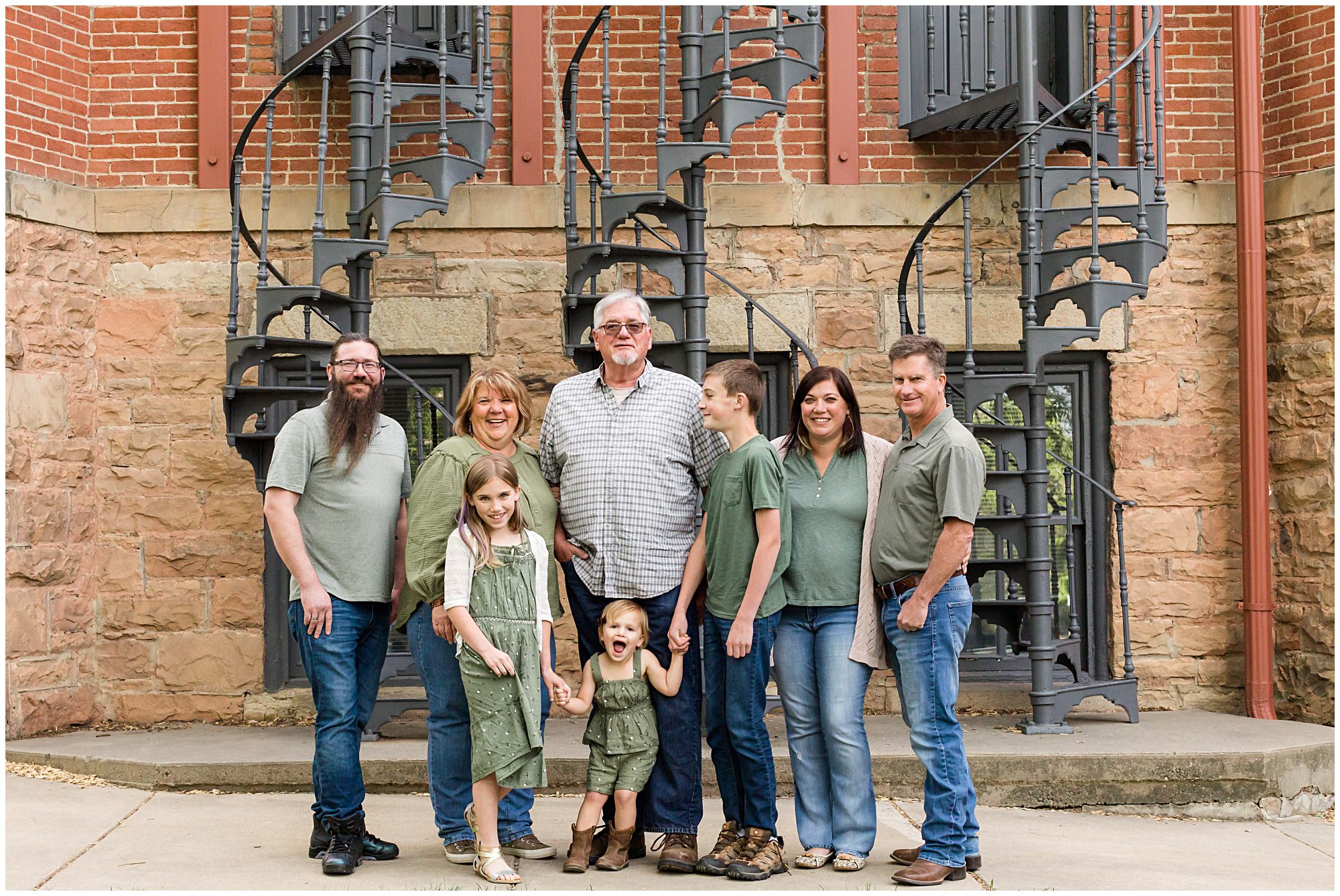 A mother and father celebrating their 38th wedding anniversary pose with their son, daughter, son-in-law, and three grandchildren to mark the occasion