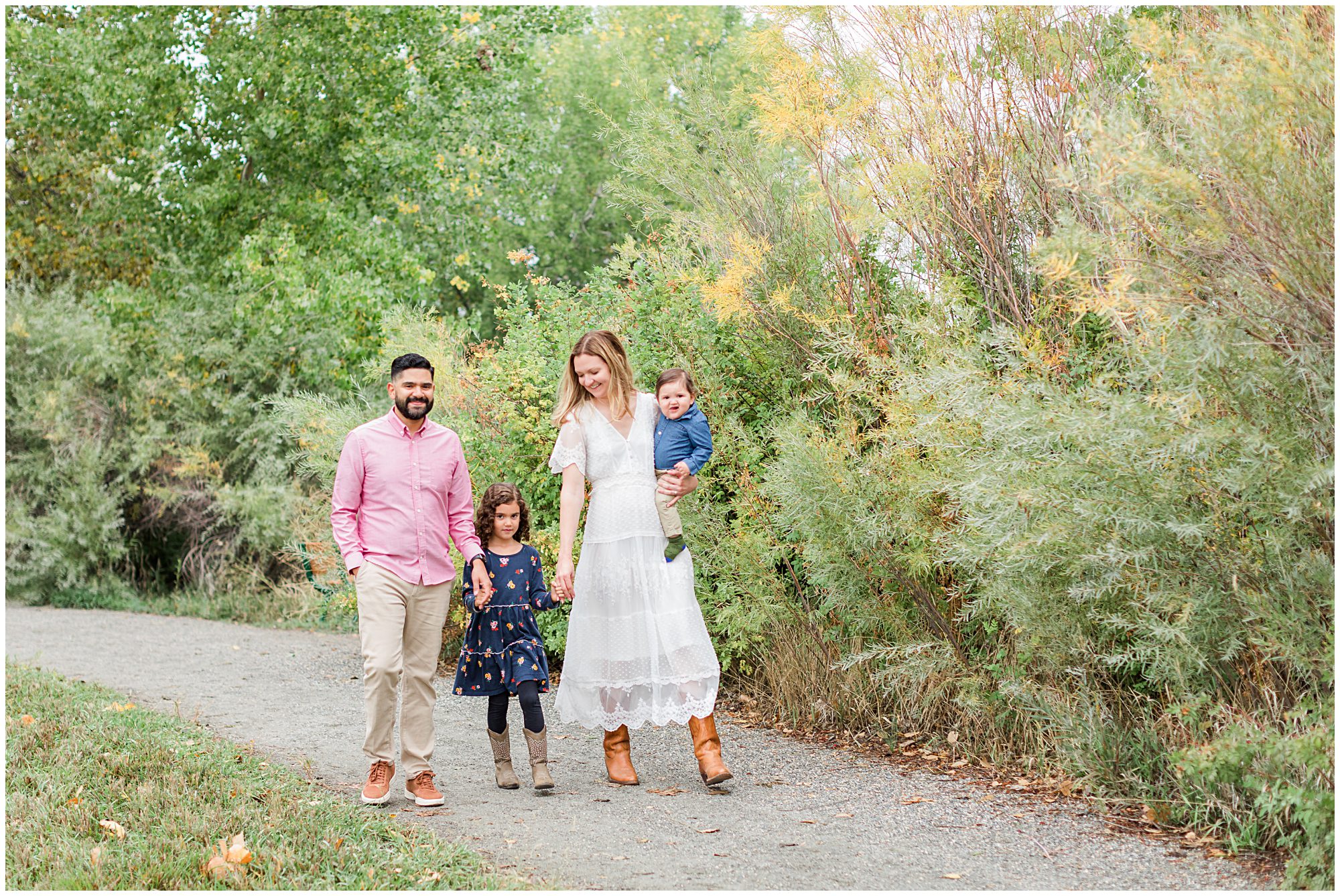 A mother and father walk with their two young children during their fall mini session at Thomas Reservoir