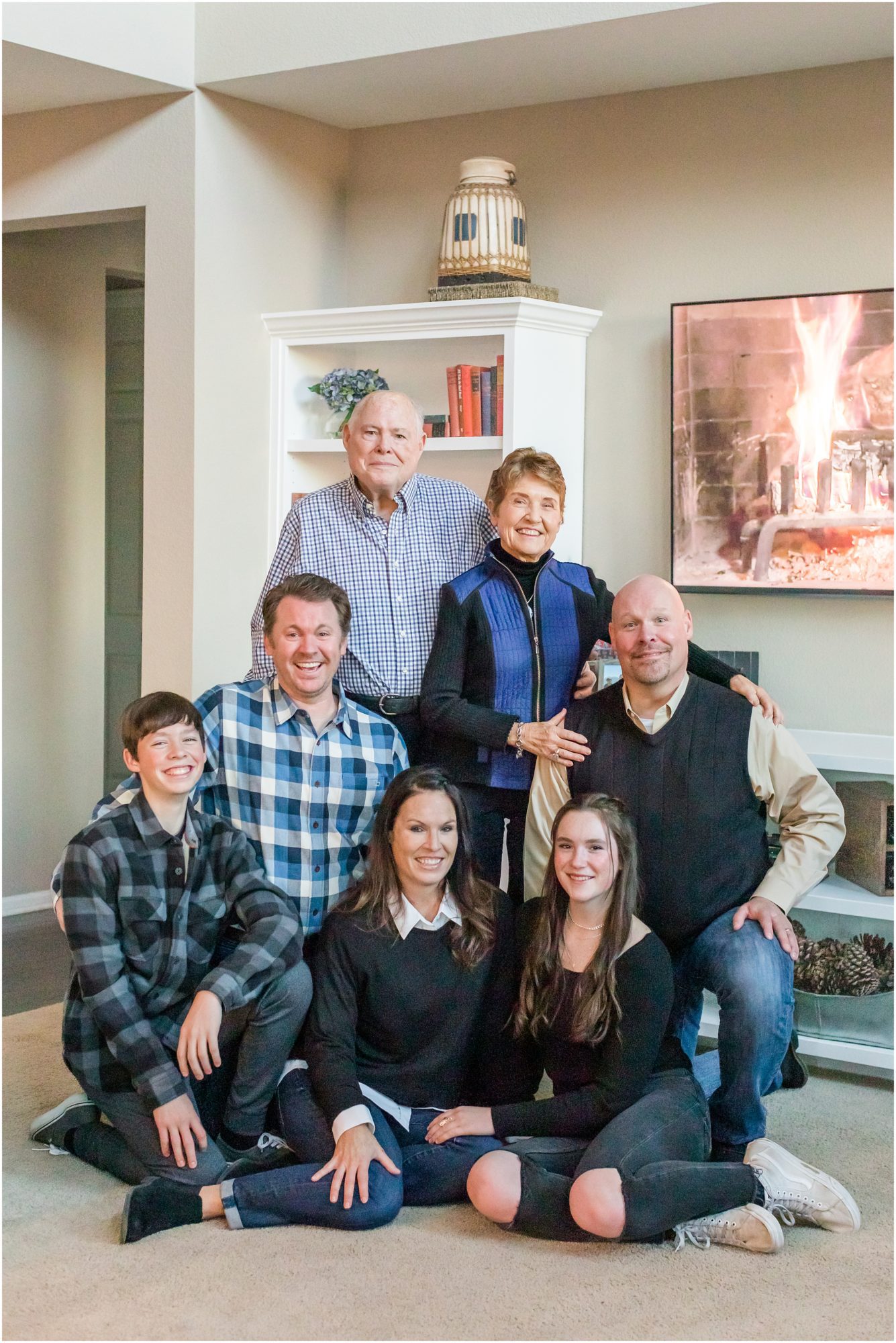 A family pose on the floor of their living room during an extended family session