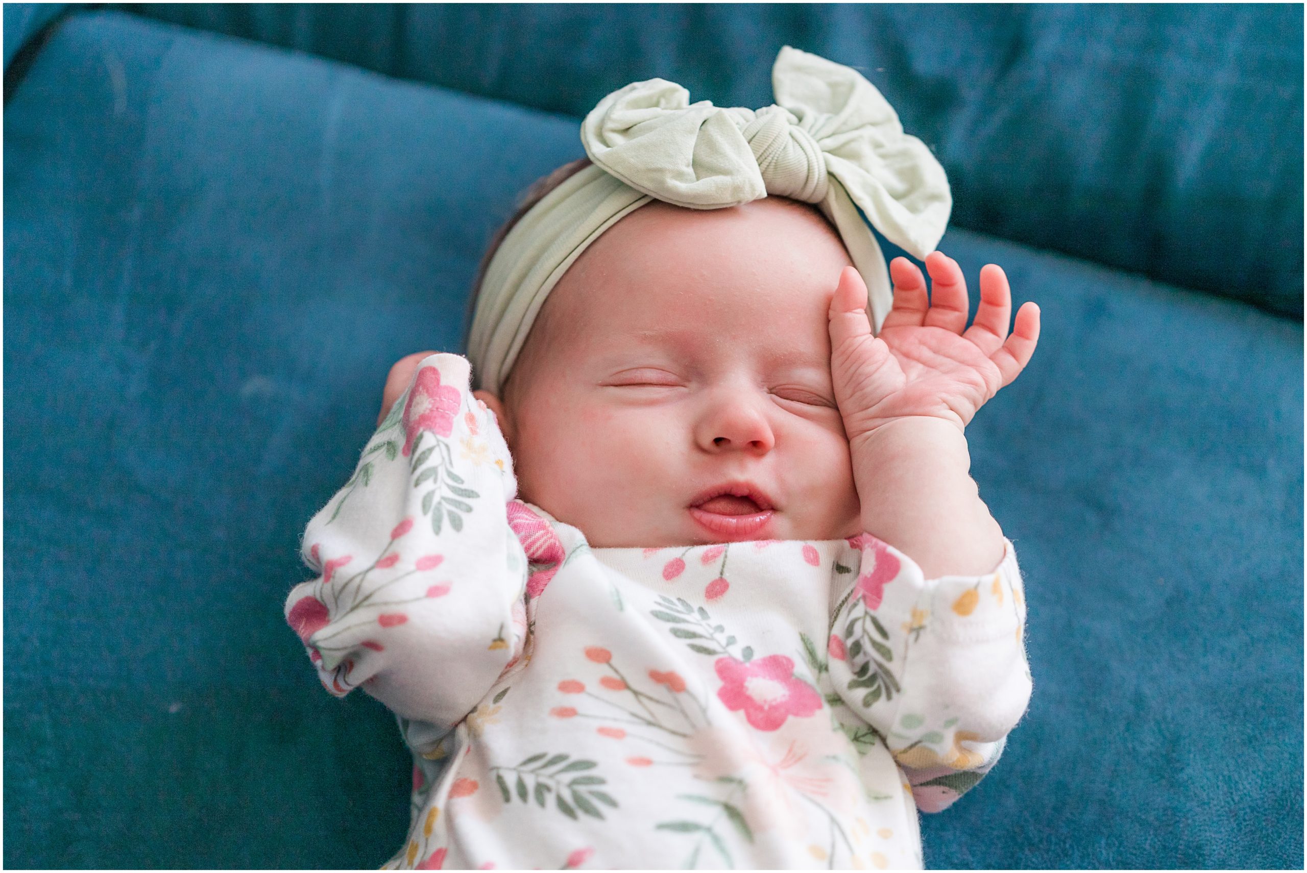 A photo of a baby girl sleeping on a sofa taken during an in-home newborn session by Theresa Pelser Photography