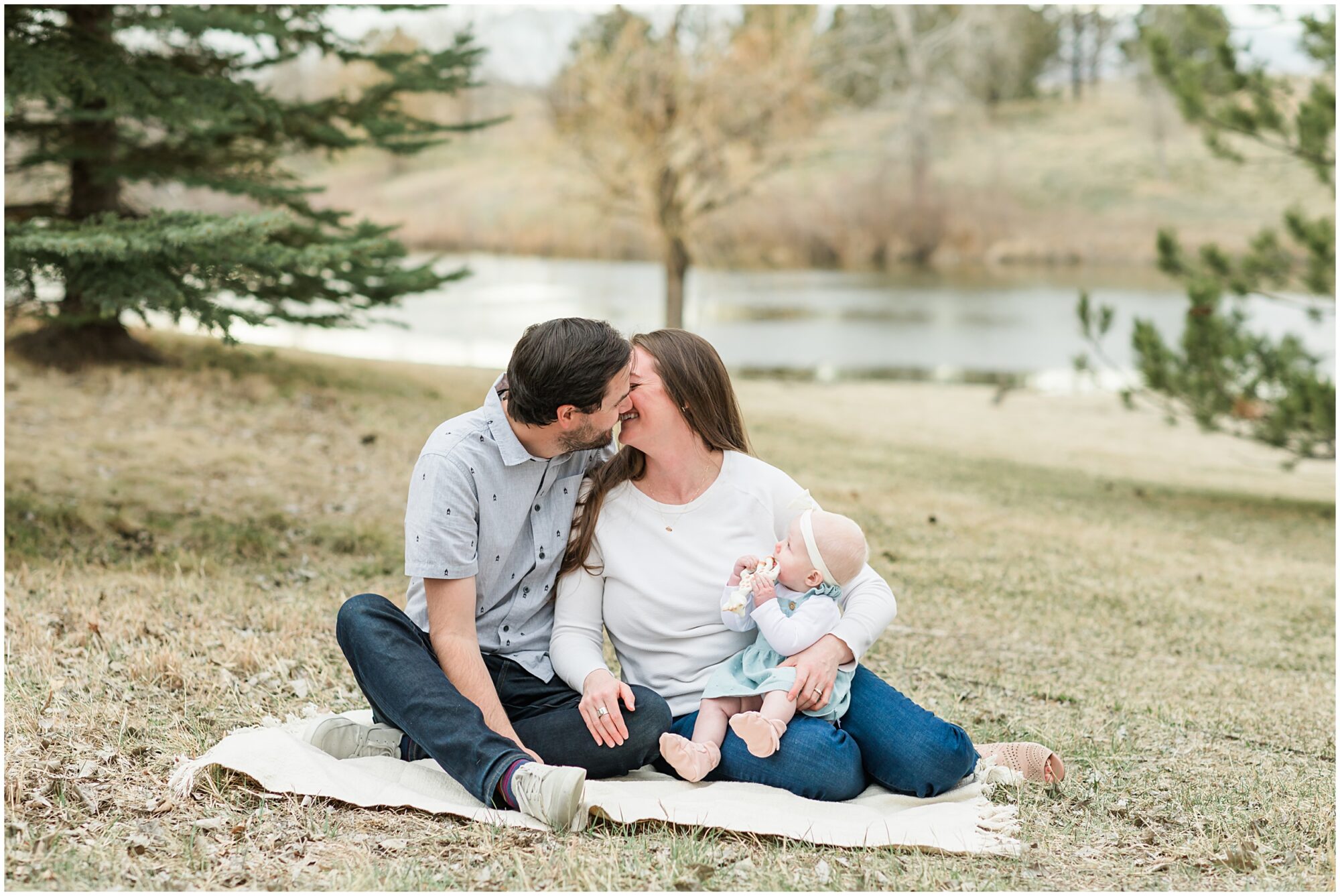 A candid photo baby watching her father and mother kiss captured during their family session with Theresa Pelser Photography