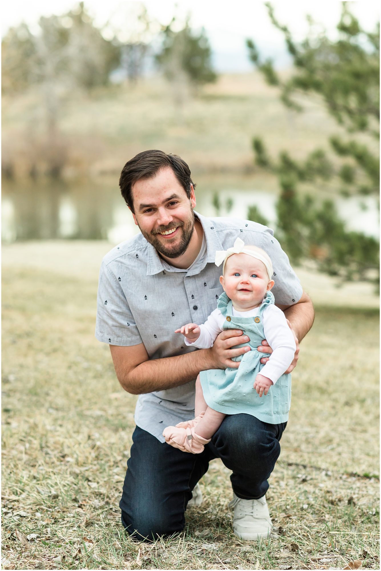 A photo of a father and his baby girl smiling at the camera captured during their family session with Theresa Pelser Photography