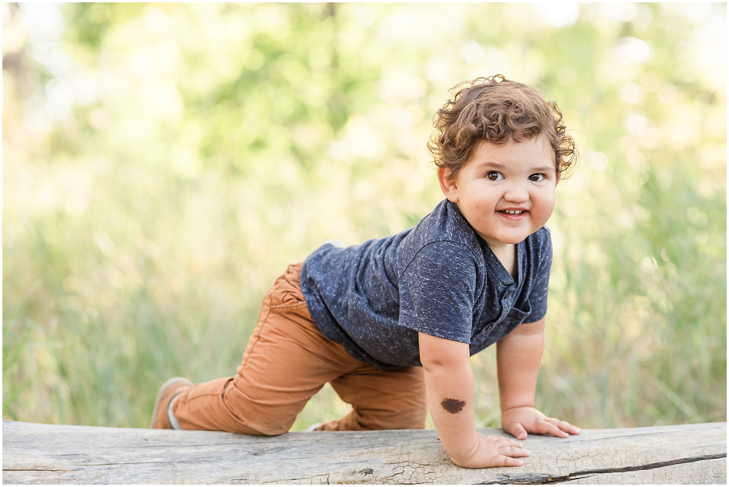 Toddler's candid smile at McKay Lake, photographed during a mini family session by Erie family photographer
