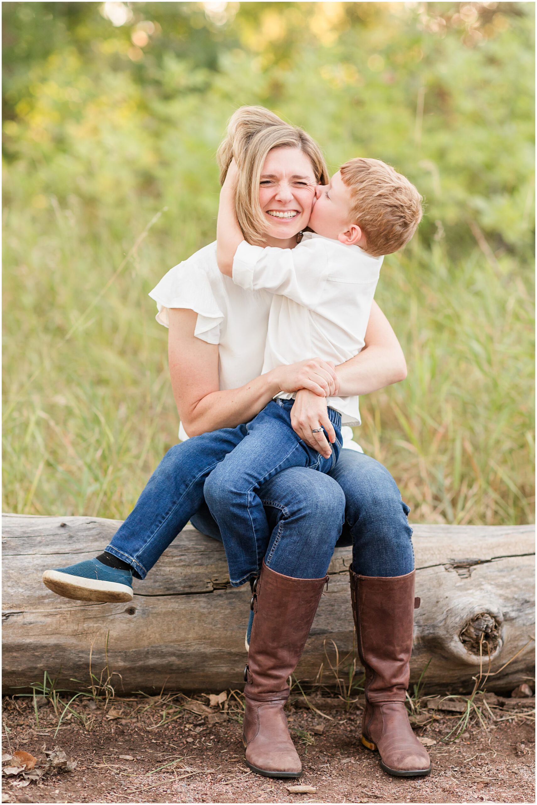Boy kisses mother's cheek in a joyful moment, captured in a mini family session by Theresa Pelser Photography