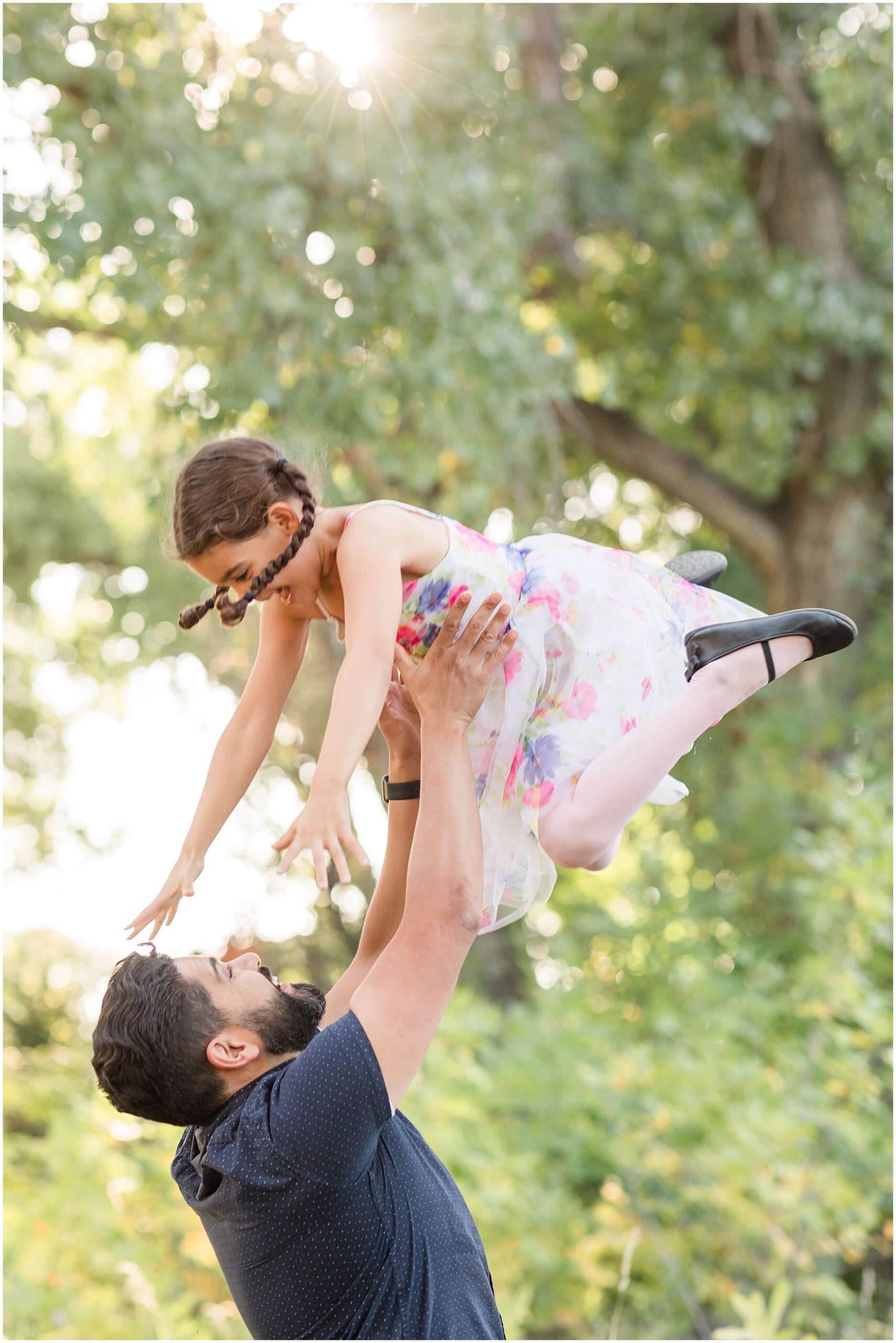 Dad and daughter share a joyful moment, captured in a mini family session by Theresa Pelser Photography