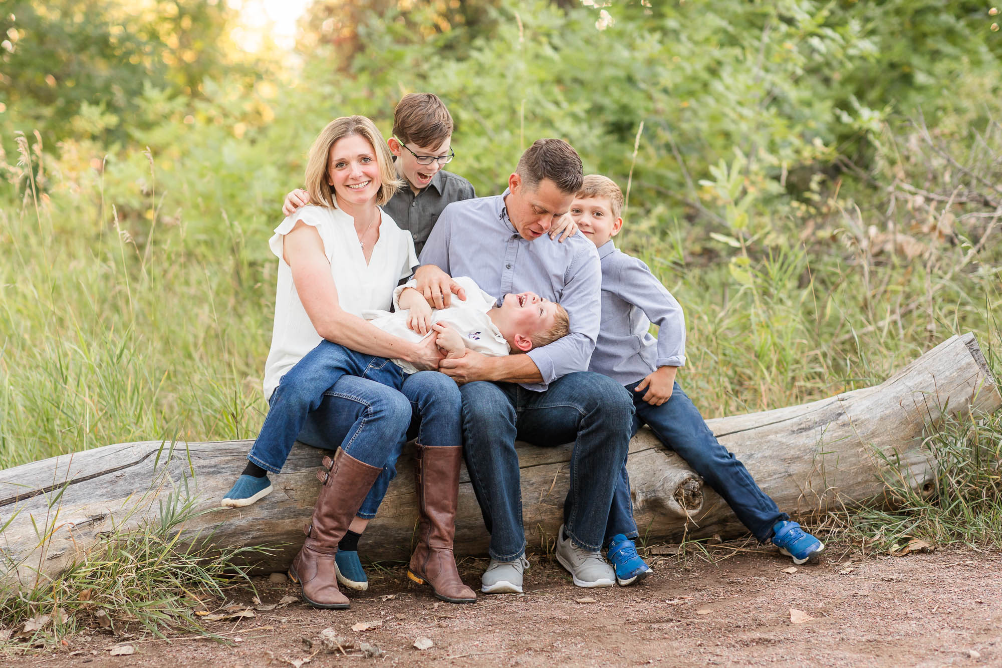 Smiling family of five during an outdoor photo session, captured by Erie family photographer.