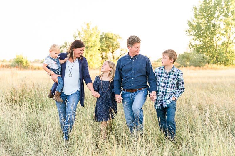 Family of five wearing mix and match shades of blue for casual and coordinated outfits for family photos.