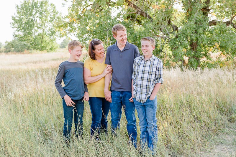 Family with teens in coordinating muted fall tones for casual and natural family photo clothing inspiration.