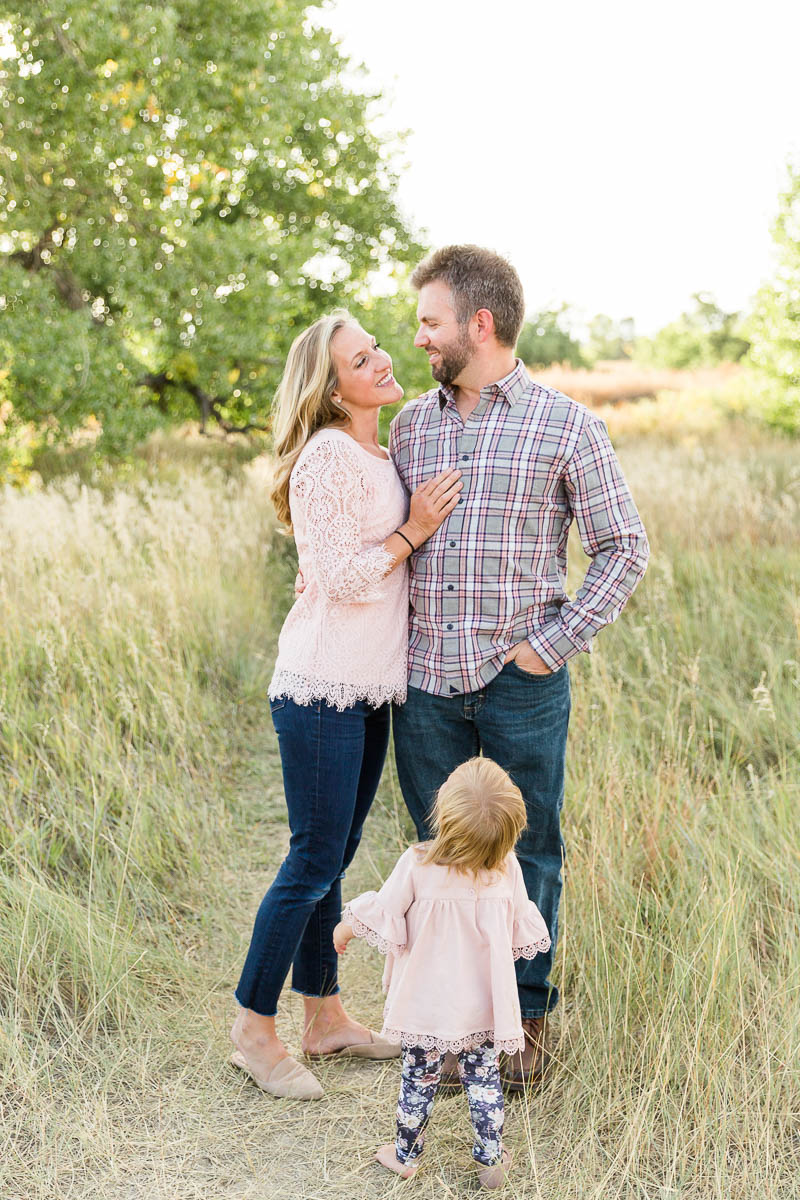 A photo of parents together with their young daughter