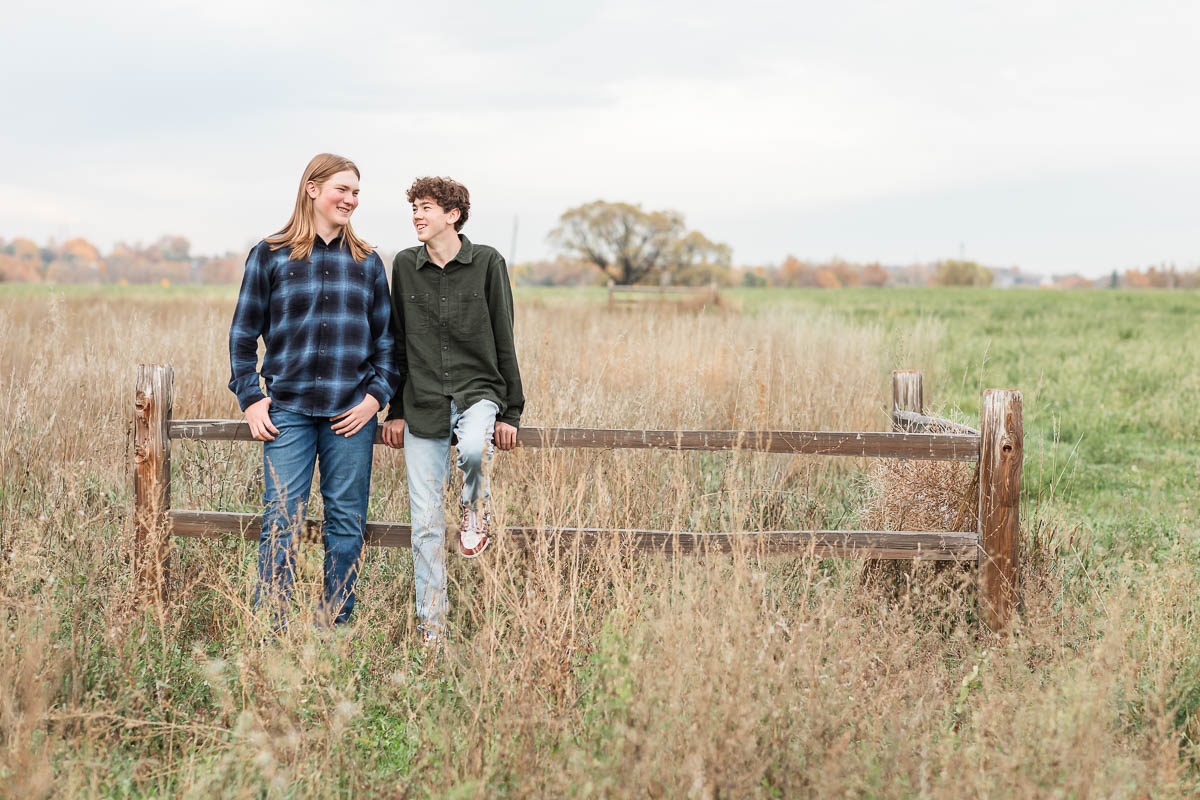 Two siblings standing together during an outdoor family photo session in Erie, CO.